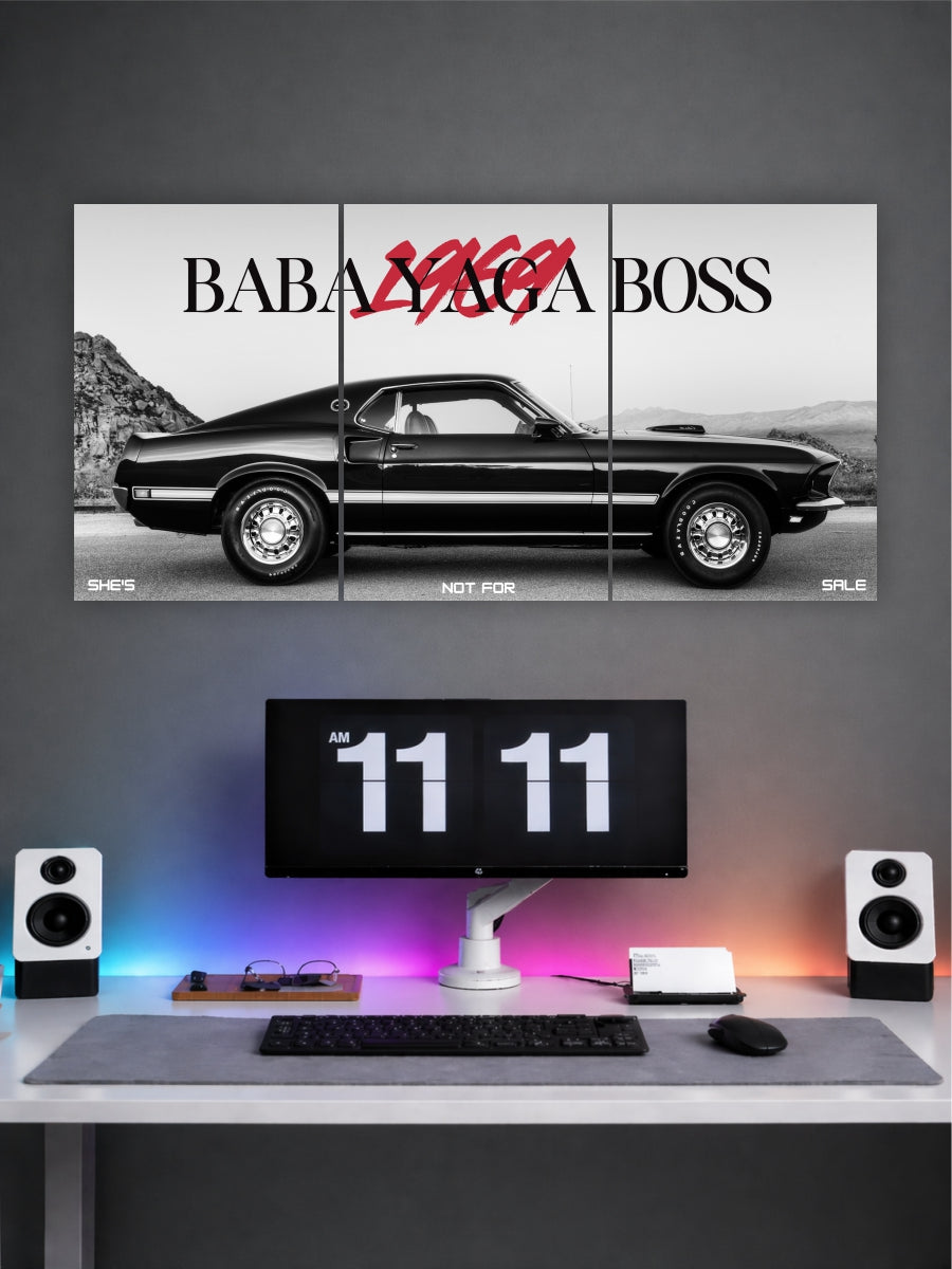 Triptych wall art of a black car with 'Baba Yaga Boss' text above a desk setup.