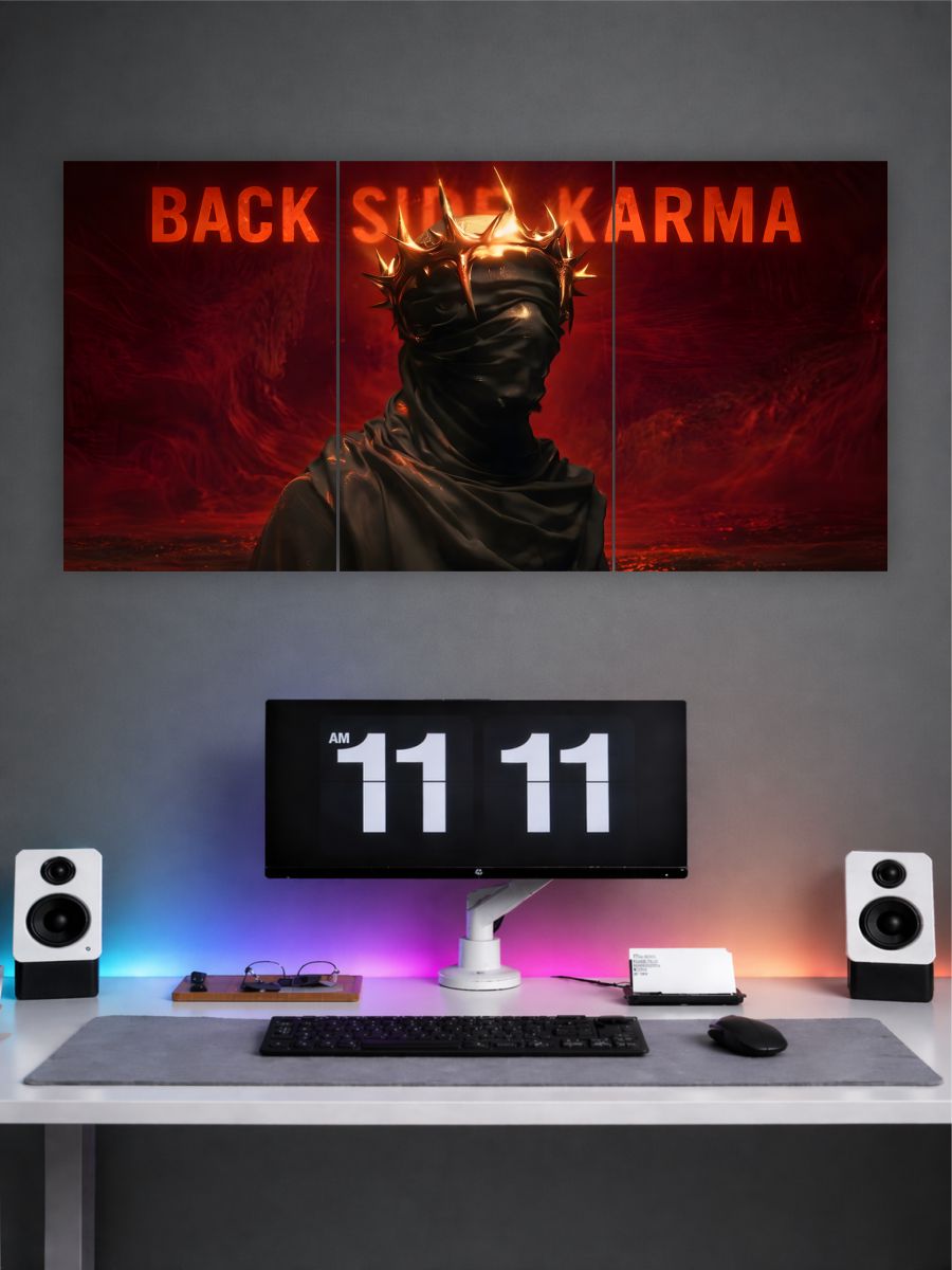 Wall art with a masked figure and 'Back Side Karma' text above a computer setup.