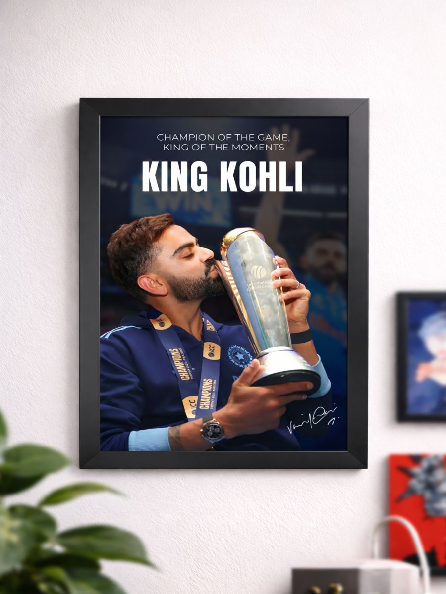 Framed poster of a person holding a trophy with 'King Kohli' text on a wall.
