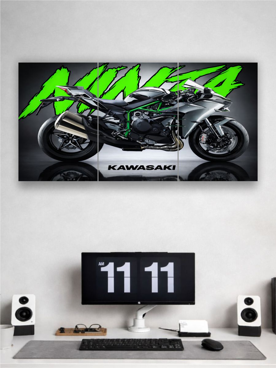 Kawasaki motorcycle poster on a wall above a computer setup.