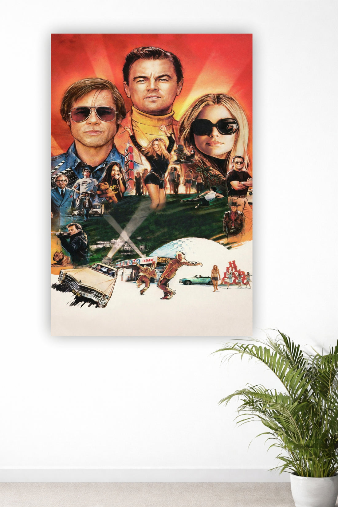 A vertical canvas wall art print featuring a collage of Leonardo DiCaprio and Brad Pitt from the movie 'Once Upon a Time in Hollywood' on a white wall, with a green potted plant visible in the lower right corner.