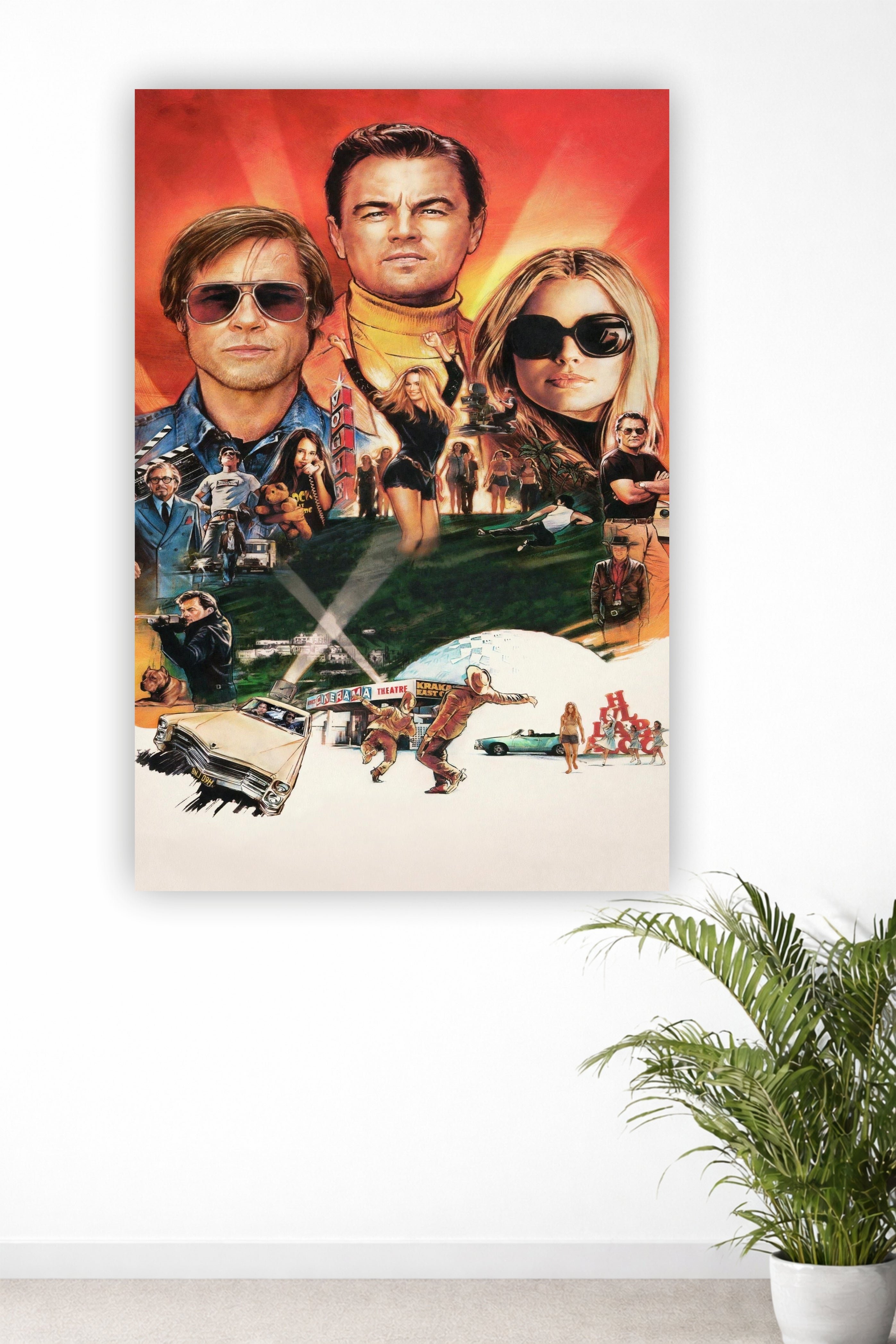 A vertical canvas wall art print featuring a collage of Leonardo DiCaprio and Brad Pitt from the movie 'Once Upon a Time in Hollywood' on a white wall, with a green potted plant visible in the lower right corner.